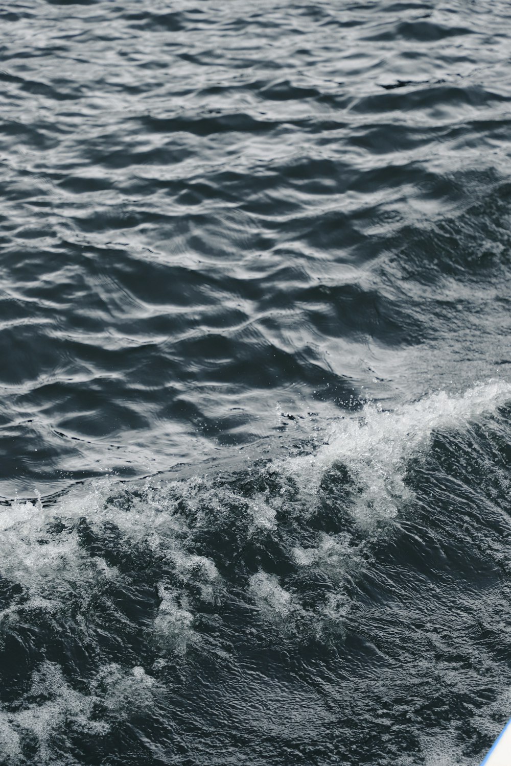 water waves on blue ocean water during daytime