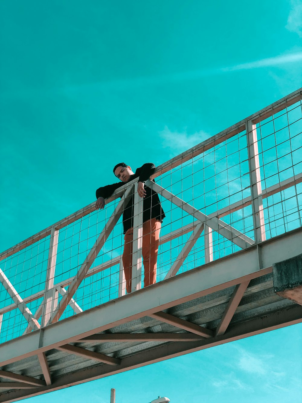 man in black jacket standing on top of building during daytime