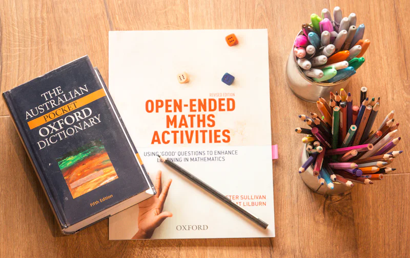 Dictionary and study materials arranged on a desk