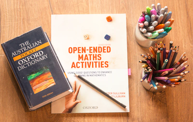 Dictionary and study materials arranged on a desk