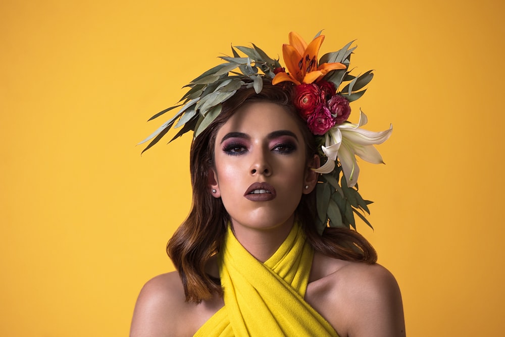 Femme en haut sans manches jaune avec coiffe de fleurs jaunes et rouges