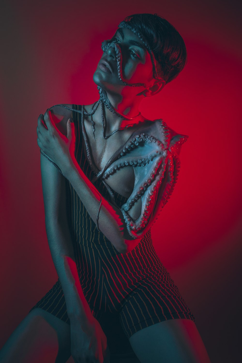 woman in black and red dress with red rose on her face