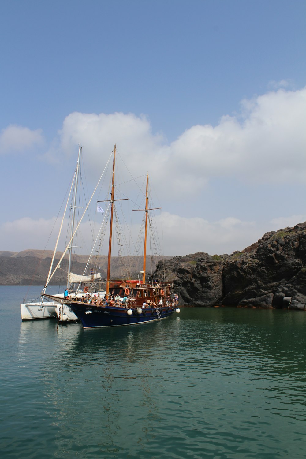 white and blue boat on sea during daytime