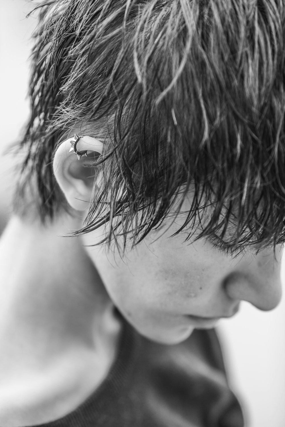 grayscale photo of woman with silver earrings