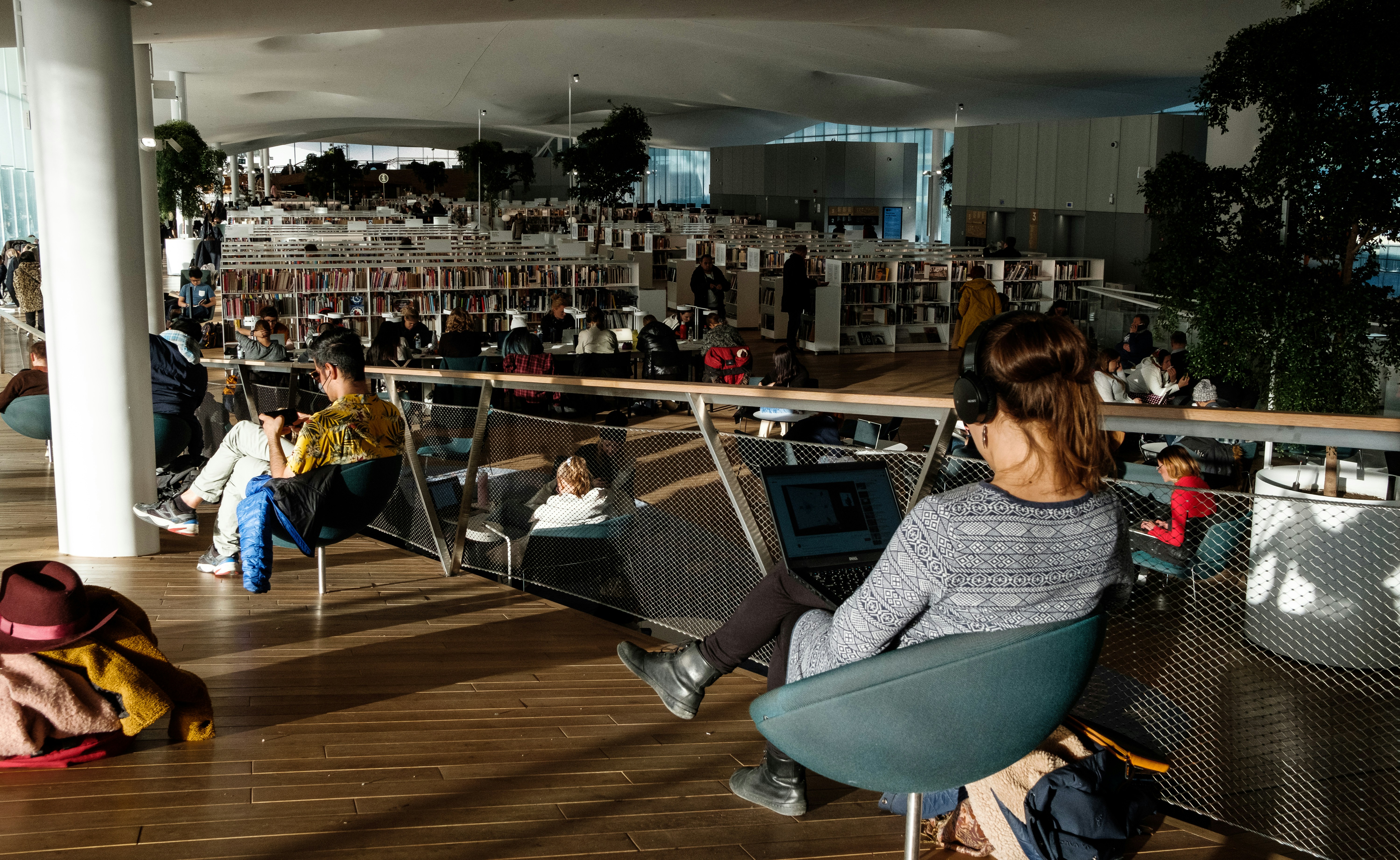 woman in gray and black shirt sitting on chair