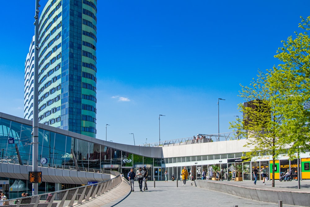 a tall building sitting next to a street filled with people