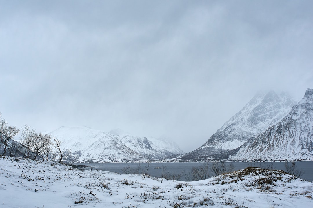 snow covered mountain under white cloudy sky during daytime