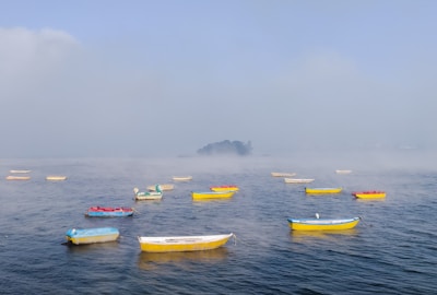 yellow and blue kayaks on sea during daytime