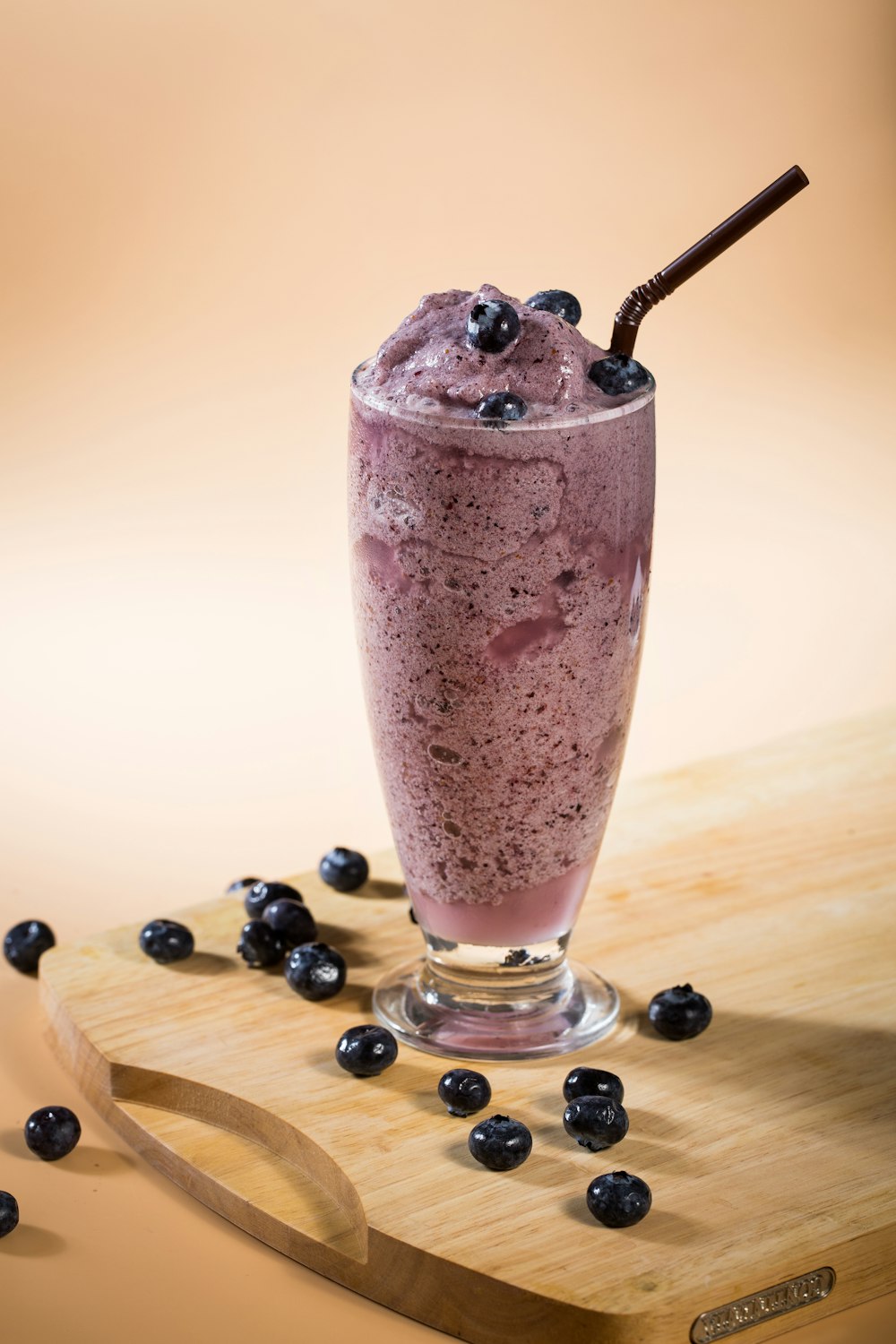 clear drinking glass with ice cream and black berries