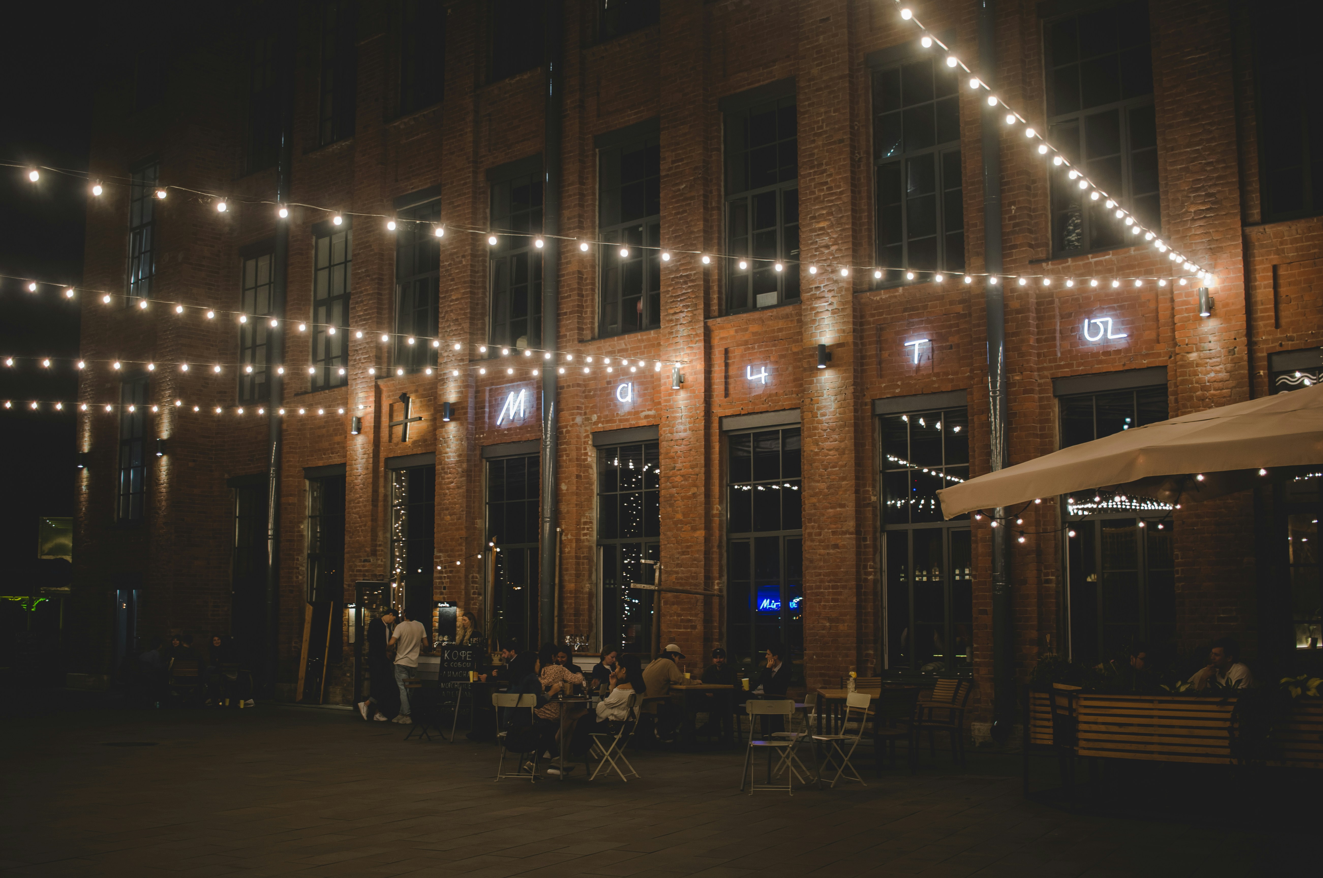 people sitting on chair near building during night time