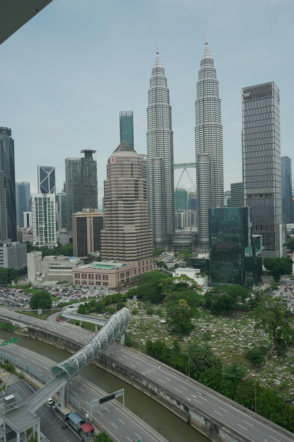 city buildings and green trees during daytime