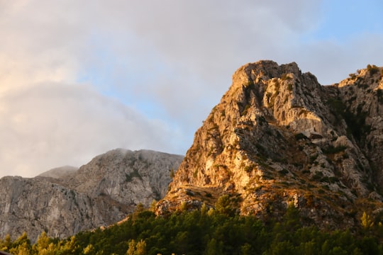 brown rock formation under white clouds during daytime in Mallorca Spain