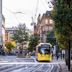 yellow and black tram on road during daytime