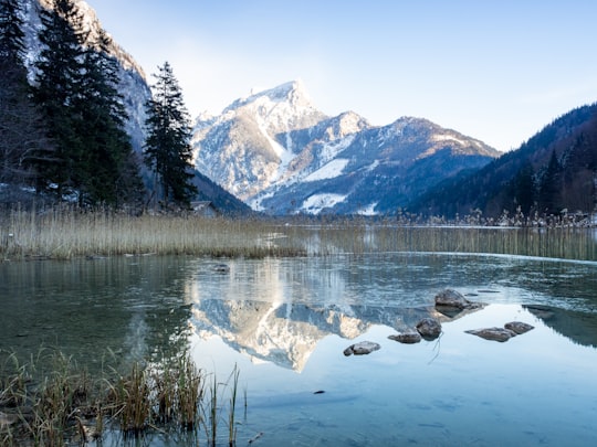 snow covered mountain near body of water during daytime in Eisenerz Austria
