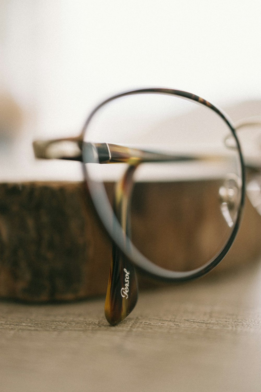 silver framed eyeglasses on gray textile