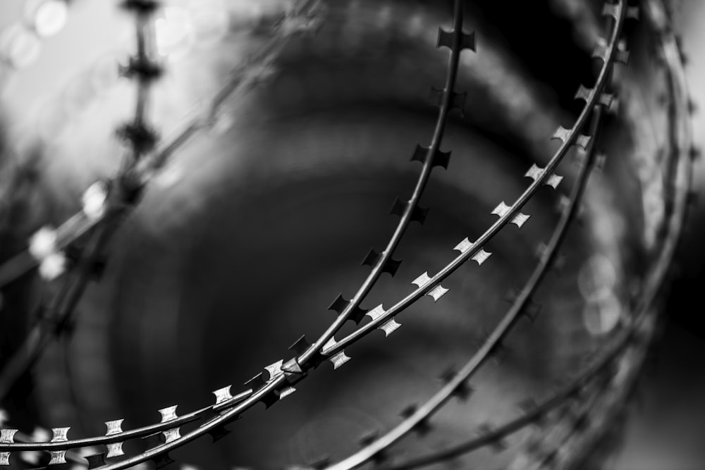 grayscale photo of metal spiral stairs