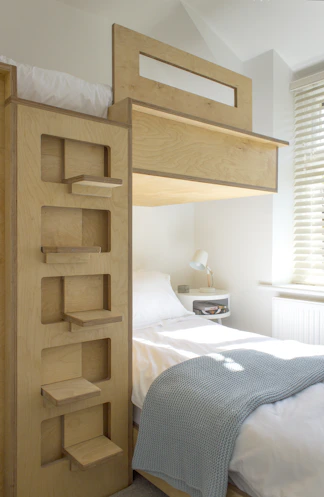 white bed linen near brown wooden bed frame