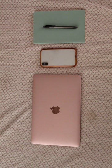 A modern laptop with colorful accessories arranged neatly beside it