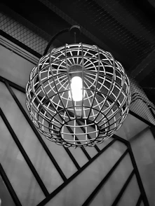 grayscale photo of round pendant lamp
