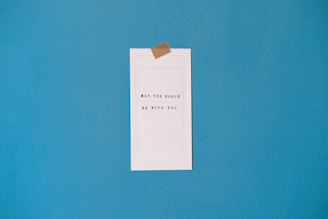 white printer paper on teal wall