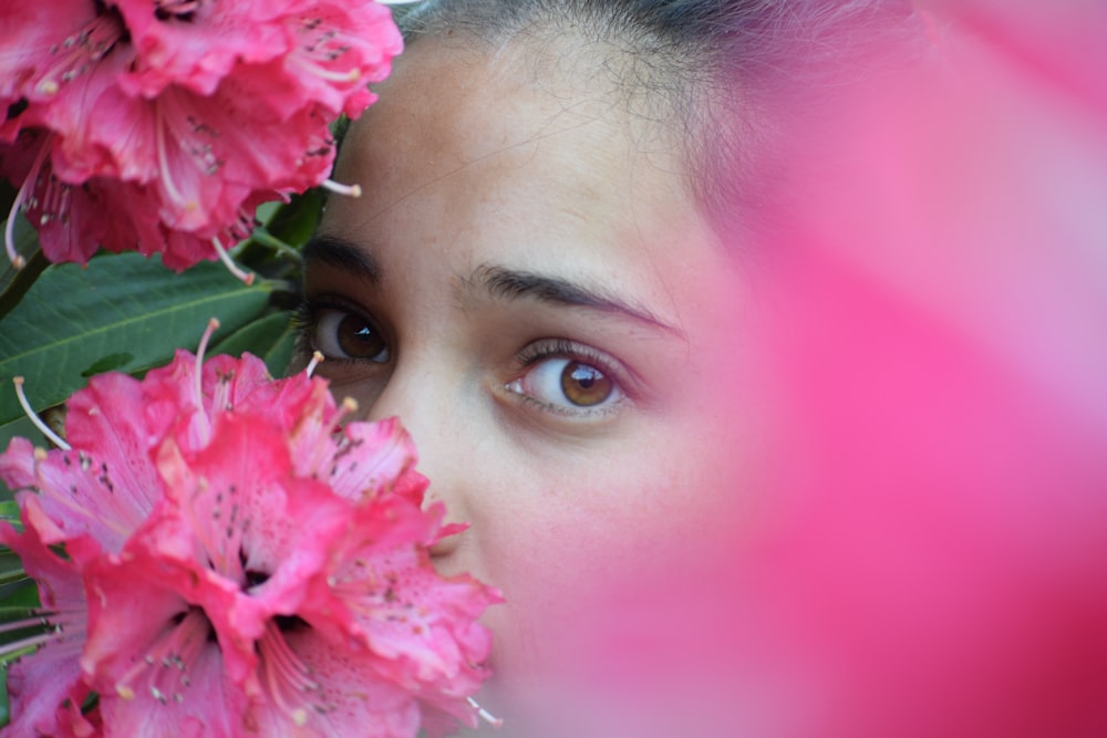 woman with pink flower on her ear