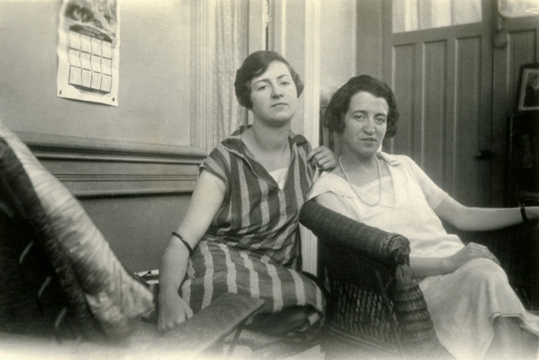 2 women sitting on couch