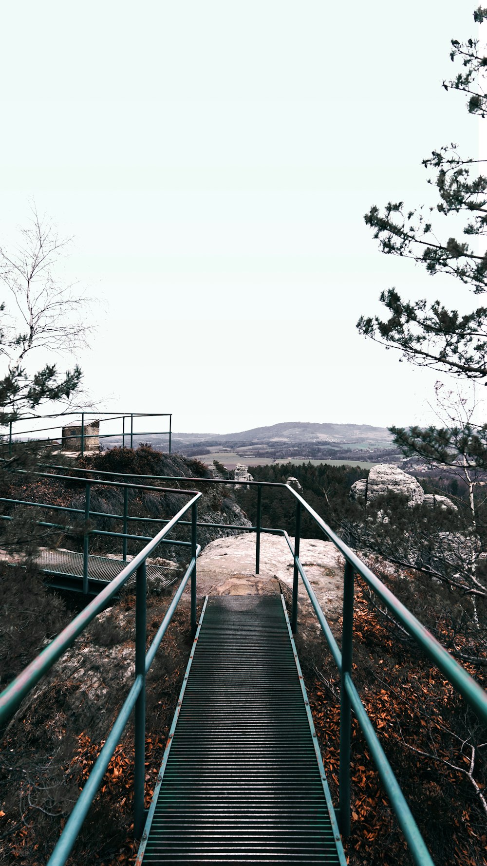 black metal railings on brown rocky mountain during daytime