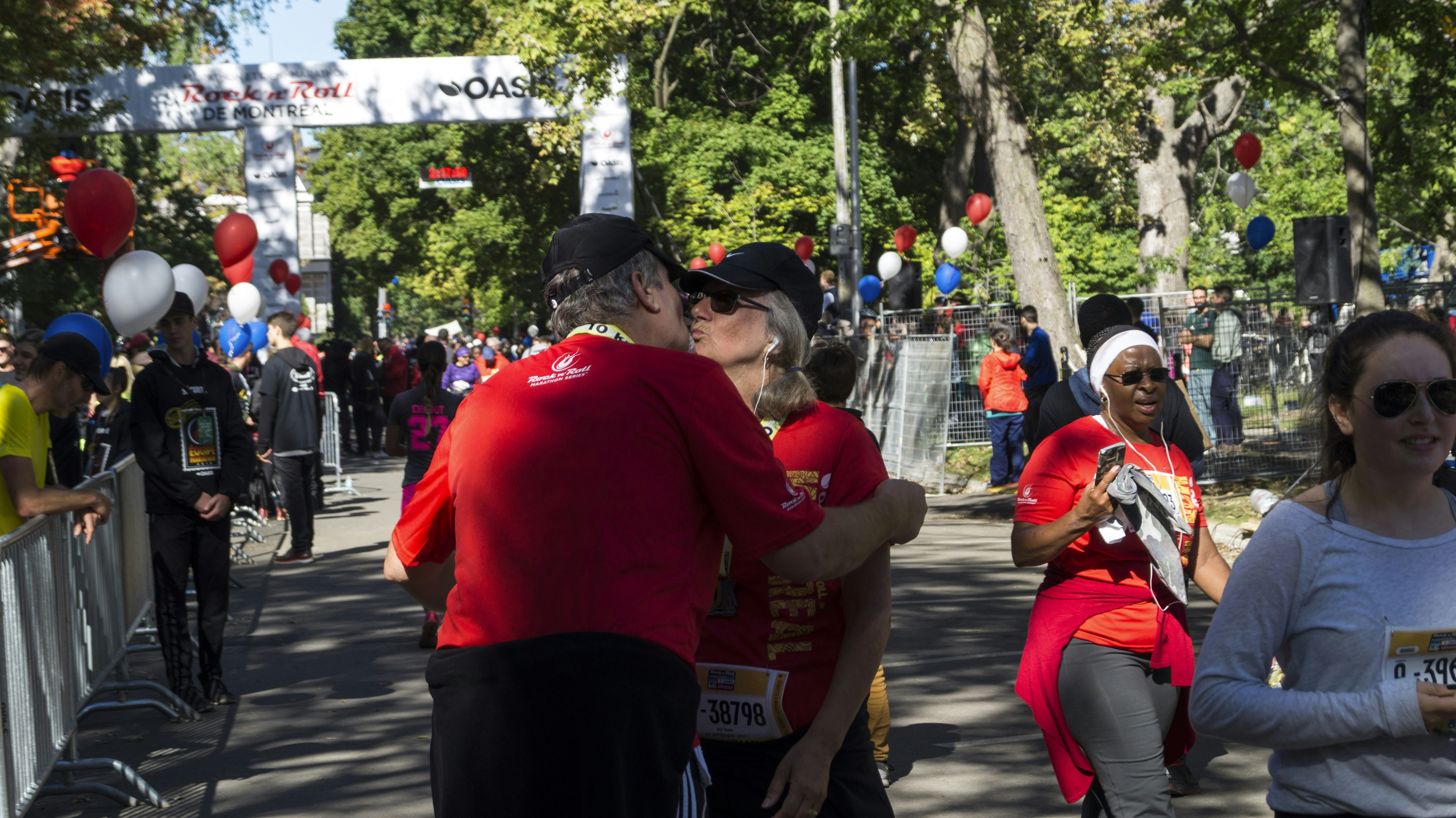 people in red shirt and black pants walking on street during daytime
