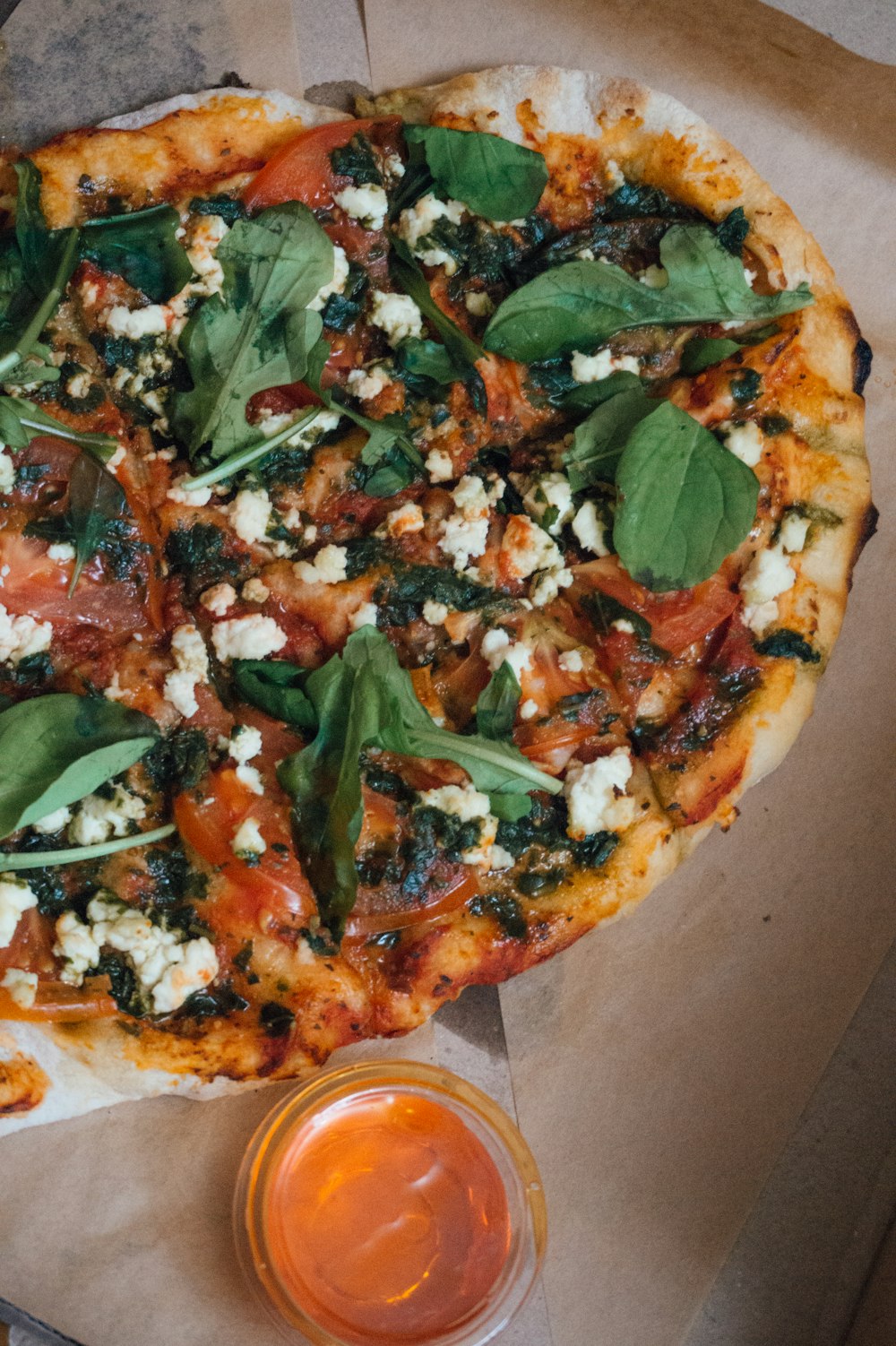 pizza with green leaves and red sauce