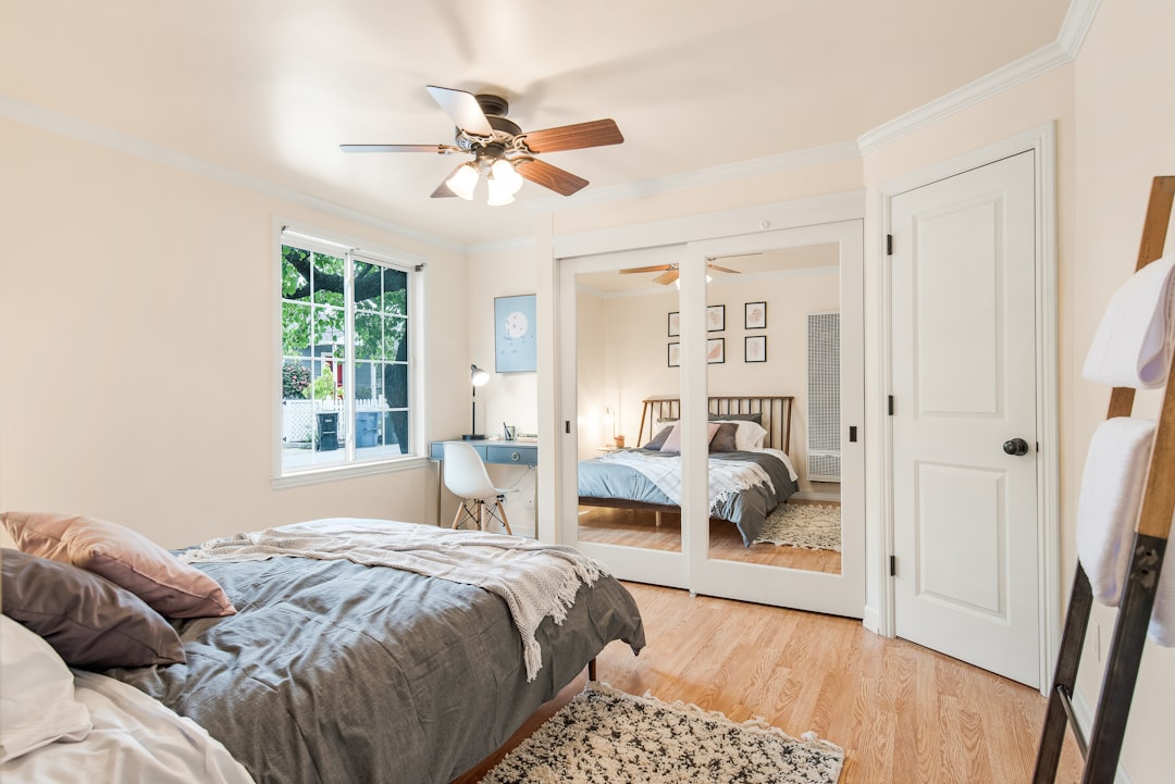  white wooden door near white bed fan