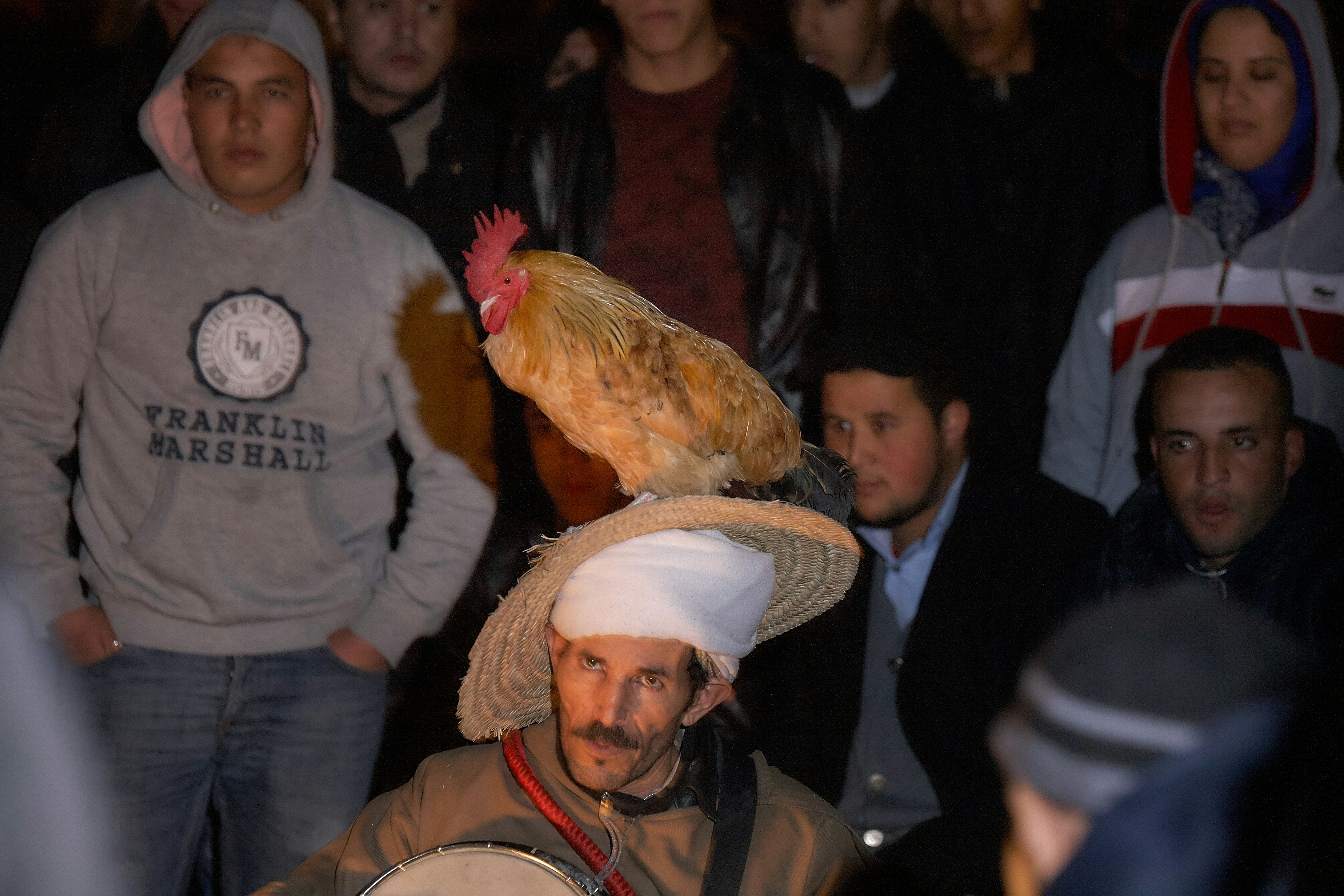 man in black leather jacket wearing white hat