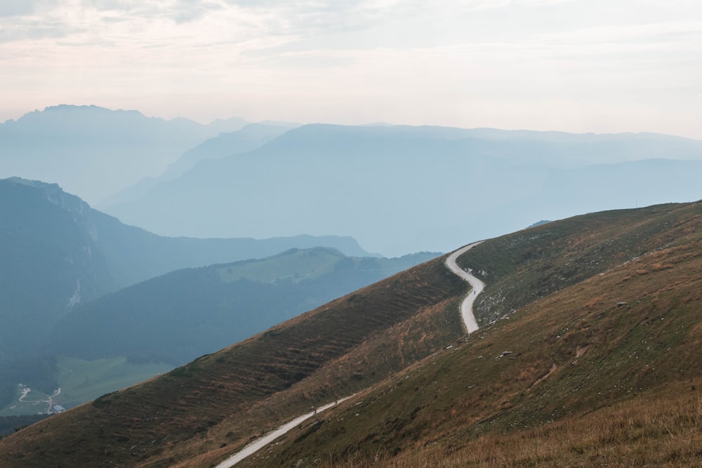 gray asphalt road on mountain during daytime