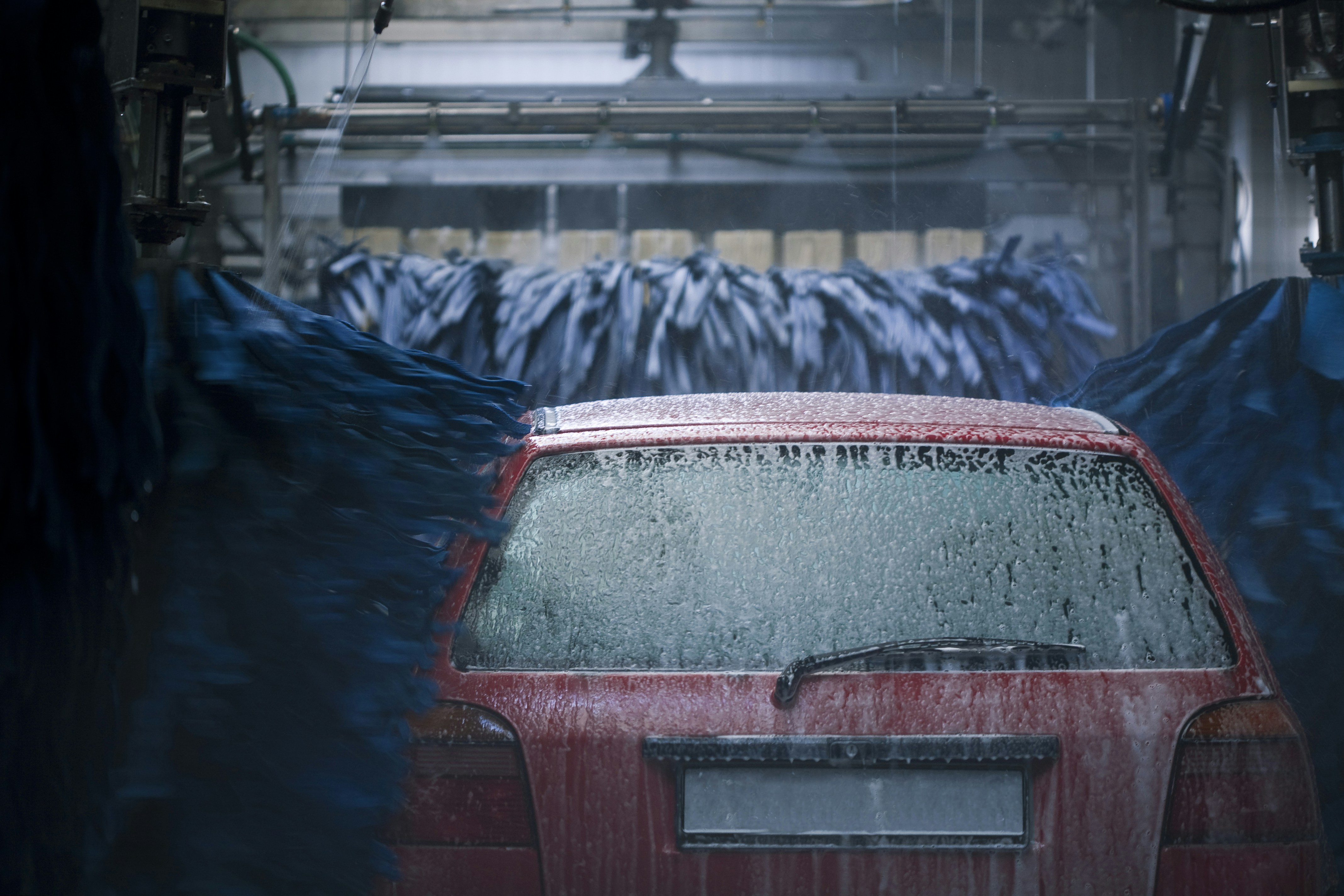 Red car going through car wash