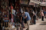 Tourists exploring traditional markets with colorful local crafts