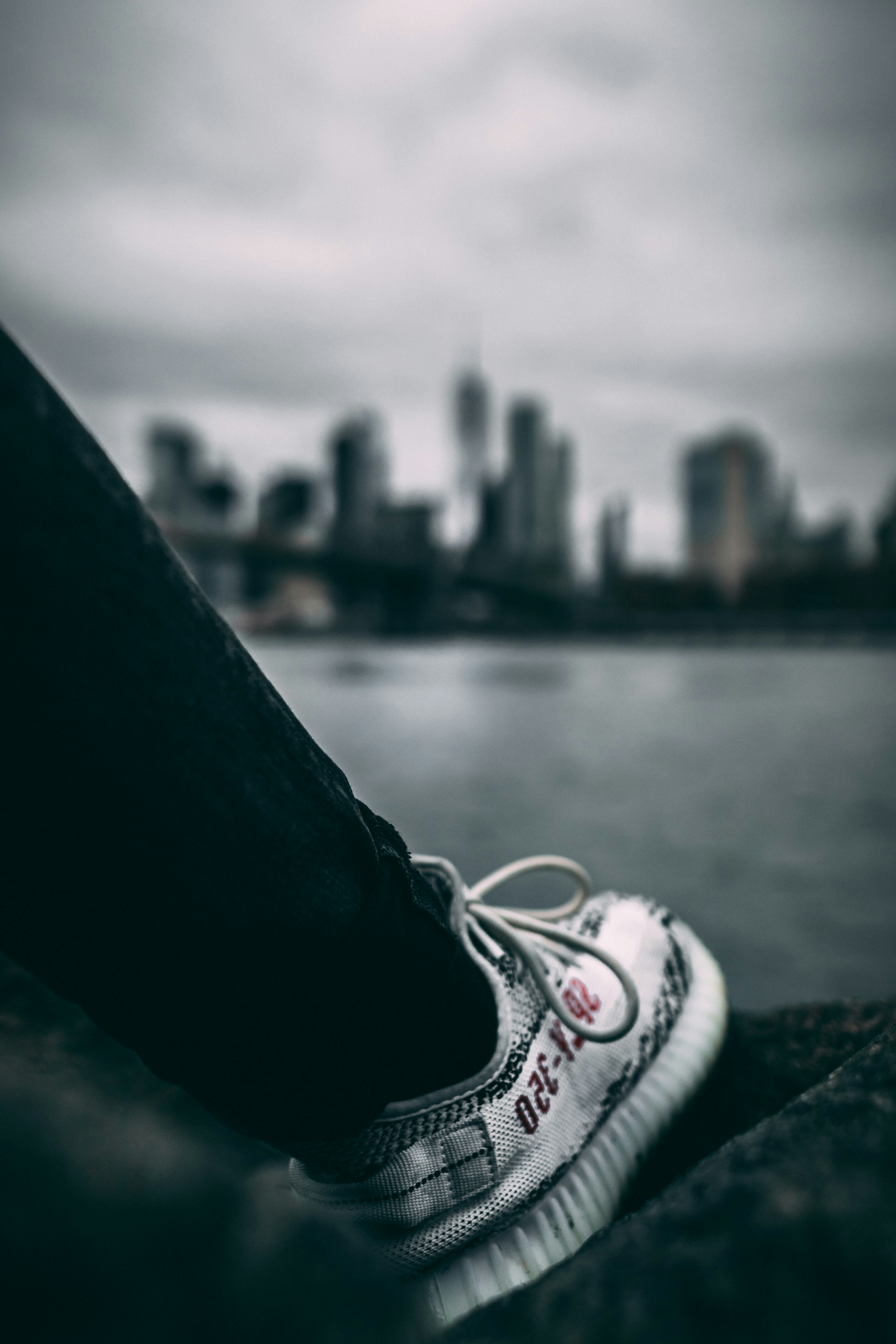 person in black pants wearing white sneakers