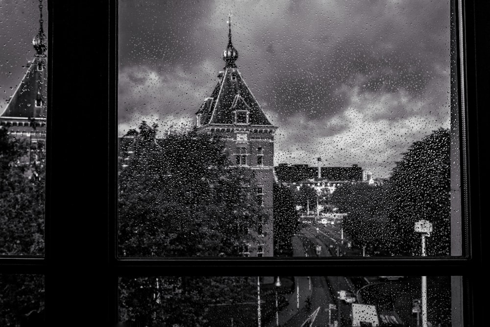 grayscale photo of castle under cloudy sky