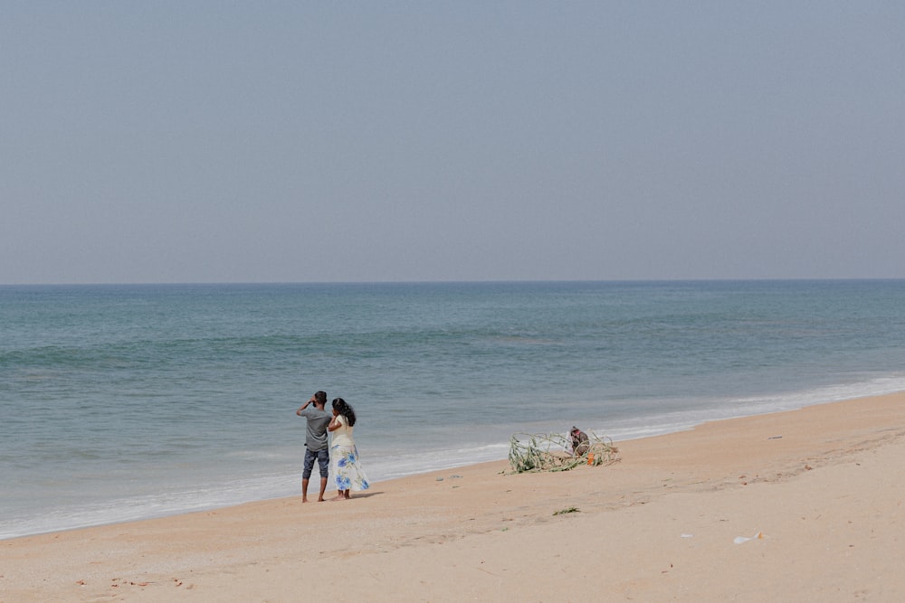 2 person walking on beach during daytime