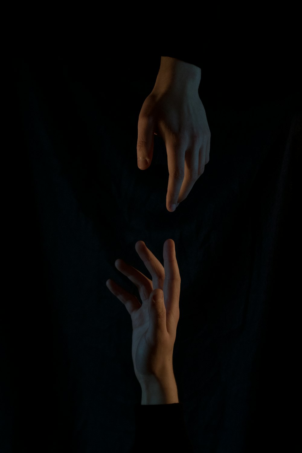 persons hand on black textile