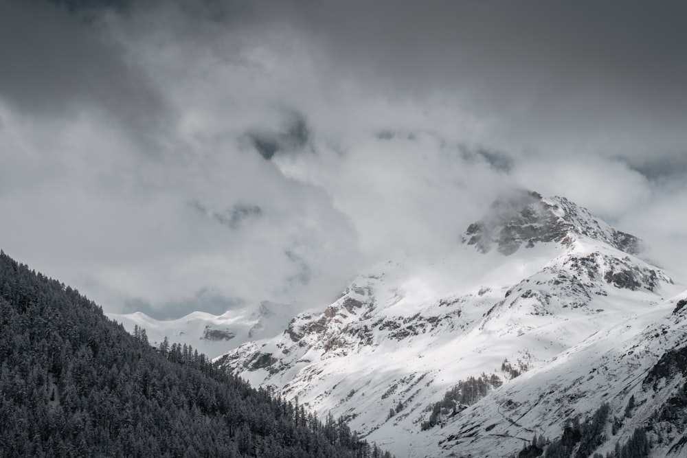 snow covered mountain under cloudy sky during daytime