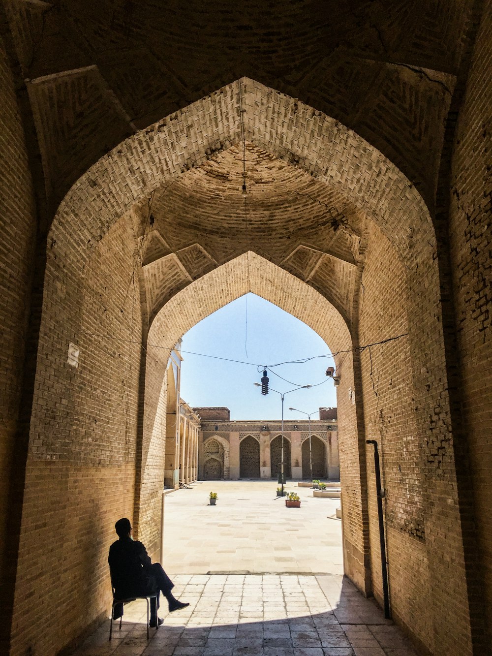 people walking inside brown brick building