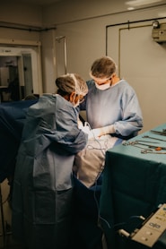 Veterinarian couple performing a surgical operation on a cat in a clean, well-equipped clinic.