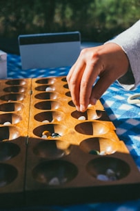 person holding brown wooden board