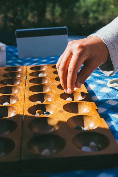 person holding brown wooden board