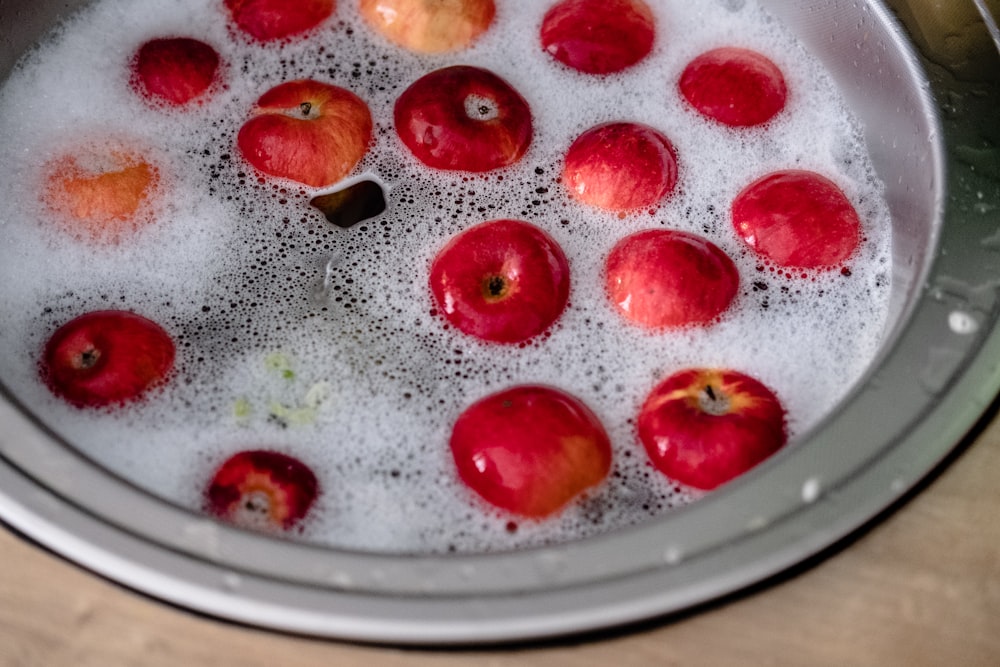 red and brown round fruit on clear glass plate
