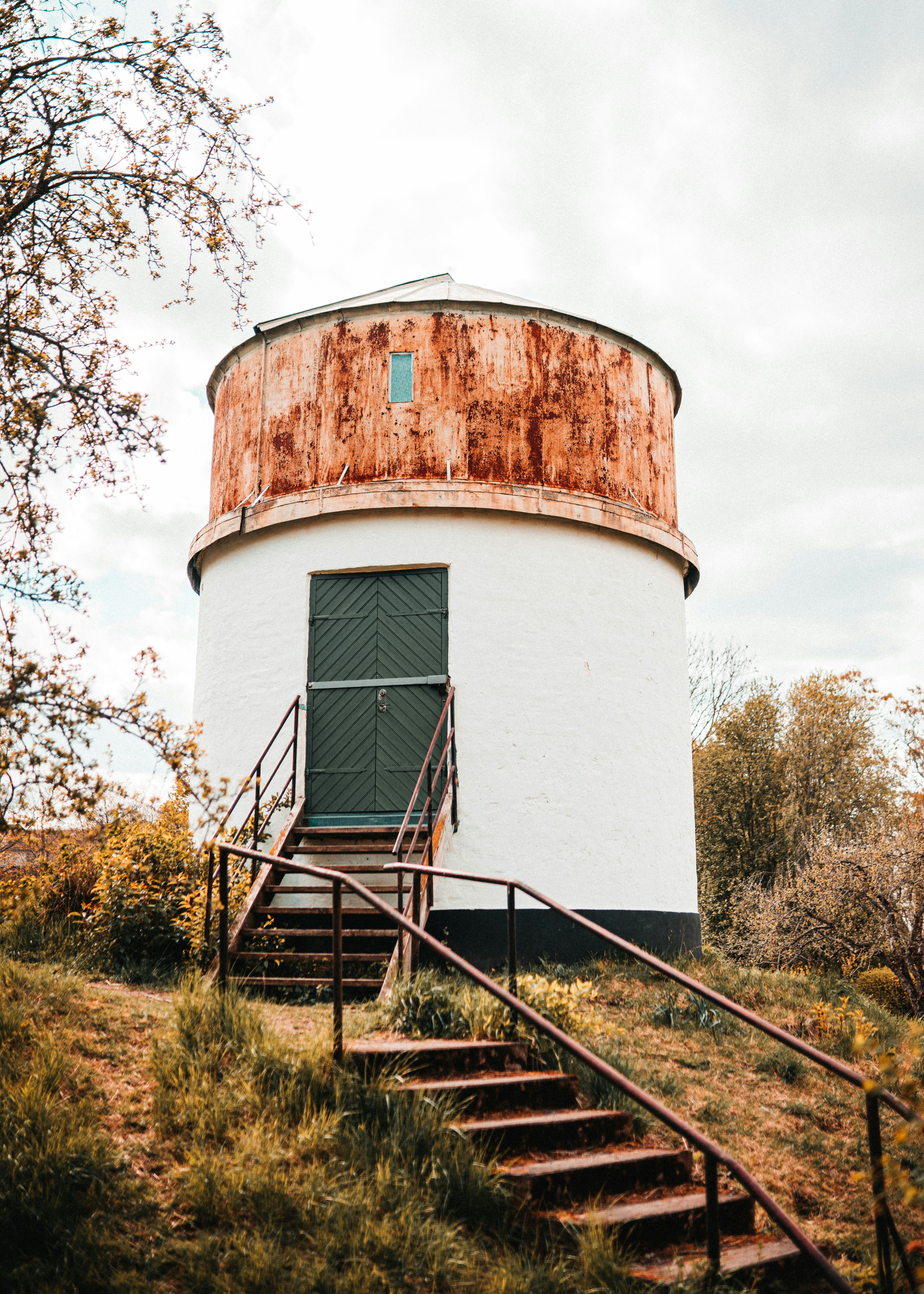 white and brown concrete building near green grass field during daytime