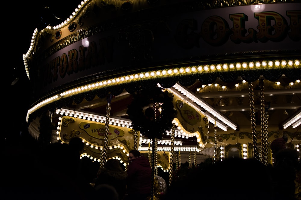 white and brown carousel with lights during night time