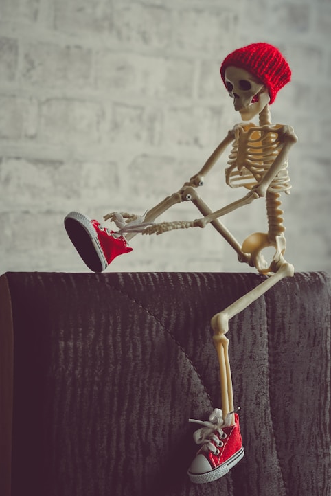 gold and red skeleton figurine