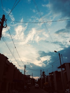 Sunset view of fiber optic cables running alongside a quiet suburban street.