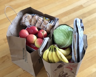 apples and bananas in brown cardboard box