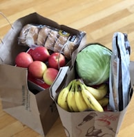 apples and bananas in brown cardboard box